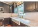 Kitchen features granite countertops, subway tile backsplash, stainless appliances, and a farmhouse style sink under the window at 13312 Edgetree Dr, Pineville, NC 28134