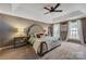 Spacious main bedroom featuring trey ceiling, large windows, and comfortable furniture at 13312 Edgetree Dr, Pineville, NC 28134