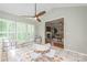 Bright playroom with tiled floor, ' table, plenty of natural light and view into the living room with fireplace at 13312 Edgetree Dr, Pineville, NC 28134