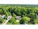 An aerial view showing the house surrounded by mature trees in a well-established neighborhood at 13914 Loch Loyal Dr, Charlotte, NC 28273