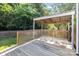 A spacious wooden back deck with a pergola and plenty of room for outdoor seating at 13914 Loch Loyal Dr, Charlotte, NC 28273
