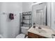 Cozy half bath with a wood vanity, modern fixtures, and storage shelving at 13914 Loch Loyal Dr, Charlotte, NC 28273