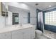 A full bathroom featuring a vanity with solid surface counters and blue tiled shower walls at 13914 Loch Loyal Dr, Charlotte, NC 28273