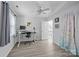 A room with a desk, a window with blue curtains, light gray flooring, and ceiling fan at 13914 Loch Loyal Dr, Charlotte, NC 28273