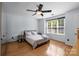 Comfortable bedroom with natural light, wood floors, and ceiling fan at 13914 Loch Loyal Dr, Charlotte, NC 28273