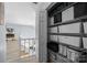 A landing closet with shelves for storage, open door showing hall and stairs with gray floors at 13914 Loch Loyal Dr, Charlotte, NC 28273