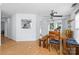 Bright dining area features a wooden table with bench seating, seamlessly connects to the kitchen through a pass-through window at 13914 Loch Loyal Dr, Charlotte, NC 28273