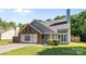 Quaint one story home featuring manicured lawn, brick and gray siding, and mature trees in a desirable neighborhood at 13914 Loch Loyal Dr, Charlotte, NC 28273