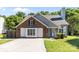 Charming single Gathering home with brick and gray siding, a concrete driveway, and well-maintained landscaping at 13914 Loch Loyal Dr, Charlotte, NC 28273