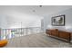 Upstairs hallway with hardwood floors, white banisters and open floor plan at 13914 Loch Loyal Dr, Charlotte, NC 28273