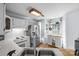 Spacious kitchen featuring white cabinets, stainless steel appliances, and a hanging pot rack by the window at 13914 Loch Loyal Dr, Charlotte, NC 28273