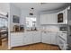 Bright kitchen featuring white cabinets, stainless appliances, and a view to the dining area through a serving hatch at 13914 Loch Loyal Dr, Charlotte, NC 28273