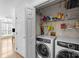 Efficient laundry room with modern washer and dryer, complemented by shelving for storage at 13914 Loch Loyal Dr, Charlotte, NC 28273