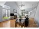 Bright living room with hardwood floors, a vaulted ceiling, fireplace, and large windows for ample natural light at 13914 Loch Loyal Dr, Charlotte, NC 28273