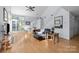 Inviting living room with hardwood floors, a staircase, and lots of natural light from the large windows at 13914 Loch Loyal Dr, Charlotte, NC 28273