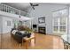Open-concept living room with high ceilings, fireplace, wood floors, and a loft area overlooking the space at 13914 Loch Loyal Dr, Charlotte, NC 28273