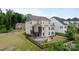 Two-story home backyard with a patio, deck, and a fenced yard at 14218 Morningate St, Huntersville, NC 28078