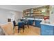 Stylish bar area featuring custom cabinetry, a sleek countertop, and a cozy dining table at 14218 Morningate St, Huntersville, NC 28078