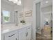Clean and modern bathroom with a quartz countertop, a large mirror, and stylish fixtures at 14218 Morningate St, Huntersville, NC 28078