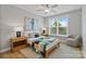 Serene bedroom with hardwood floors, bedside tables, and a cozy chair by the window, filled with natural light at 14218 Morningate St, Huntersville, NC 28078