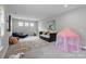Spacious bedroom featuring neutral walls, plush carpet, and a cozy area for children to play at 14218 Morningate St, Huntersville, NC 28078
