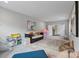 Spacious bonus room with cozy seating, colorful decor, and natural light, perfect for relaxation and entertainment at 14218 Morningate St, Huntersville, NC 28078