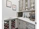 Charming butler pantry with wine storage, grey cabinetry, quartz countertops, and built-in coffee bar at 14218 Morningate St, Huntersville, NC 28078