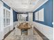 Elegant dining room with coffered ceiling, stylish wallpaper, and modern chandelier at 14218 Morningate St, Huntersville, NC 28078
