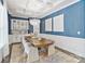 Elegant dining room with coffered ceiling, stylish wallpaper, and modern chandelier at 14218 Morningate St, Huntersville, NC 28078