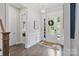Welcoming foyer with hardwood floors, wainscoting, and a view of the front door at 14218 Morningate St, Huntersville, NC 28078