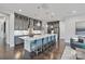 Large, modern kitchen with long island and breakfast bar, gray cabinetry, and stainless steel appliances at 14218 Morningate St, Huntersville, NC 28078