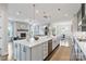 Spacious kitchen with white island, open to living room with fireplace and dining area at 14218 Morningate St, Huntersville, NC 28078