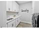 Laundry room features cabinets, counter space, and a modern washer and dryer at 14218 Morningate St, Huntersville, NC 28078