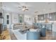 Open floor plan with modern living room flowing into kitchen featuring gray cabinetry and island seating at 14218 Morningate St, Huntersville, NC 28078