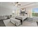 Bright main bedroom with large windows, tray ceiling, neutral tones, and tasteful décor, creating a serene retreat at 14218 Morningate St, Huntersville, NC 28078