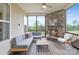 Inviting screened-in porch with stone fireplace, comfortable seating, and serene outdoor views for relaxing or entertaining at 14218 Morningate St, Huntersville, NC 28078