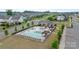 Aerial view of community pool and clubhouse surrounded by landscaping and residential homes at 14218 Morningate St, Huntersville, NC 28078