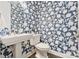 Stylish powder room with floral wallpaper, pedestal sink, and modern fixtures at 14218 Morningate St, Huntersville, NC 28078