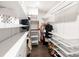 Organized walk-in closet featuring white shelving, drawers, and hanging racks for optimal storage and convenience at 14218 Morningate St, Huntersville, NC 28078