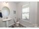 Well-lit bathroom features modern fixtures, pedestal sink, and decorative accents at 1479 Mocksville Hwy # 23, Statesville, NC 28625