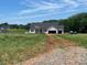 New construction home on large lot with two-car garage showcasing potential for landscaping at 1479 Mocksville Hwy # 23, Statesville, NC 28625