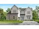 Charming two-story home featuring stone accents, shutters, and a welcoming blue front door at 15743 Sweet Virginia Ln, Huntersville, NC 28078