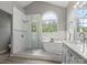 Spacious bathroom featuring a glass shower, soaking tub, and double vanity at 1579 Matthews Dr, Rock Hill, SC 29732