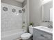 Well-lit bathroom featuring marble-tiled shower, gray vanity with sink and toilet at 1579 Matthews Dr, Rock Hill, SC 29732