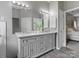 Double vanity sink area with a large mirror, and view into bedroom at 1579 Matthews Dr, Rock Hill, SC 29732