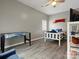 Well-lit bedroom with wood flooring, and a bed with white and blue patterned linens at 1579 Matthews Dr, Rock Hill, SC 29732