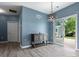 Dining area with wood flooring, modern chandelier, and a sliding glass door leading to the backyard at 1579 Matthews Dr, Rock Hill, SC 29732