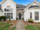 This home's entryway features an arched window, stone accent wall, and manicured landscaping at 1579 Matthews Dr, Rock Hill, SC 29732