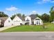 Traditional home with stone accent wall, beautiful windows, and attached garage on a lush green lawn at 1579 Matthews Dr, Rock Hill, SC 29732