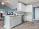 Modern kitchen featuring white cabinets, stainless steel appliances, marble countertop, and an eat-in peninsula at 1579 Matthews Dr, Rock Hill, SC 29732
